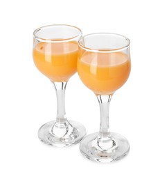 Photo of Tasty tangerine liqueur in glasses isolated on white