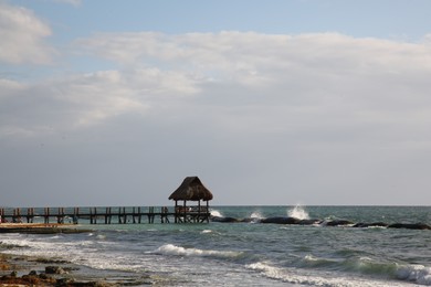 Photo of Gazebo in sea near tropical beach on sunny day