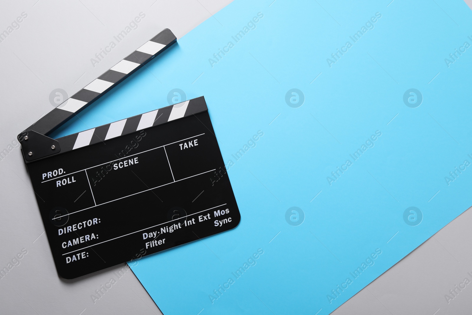 Photo of Clapperboard on color background, top view. Space for text