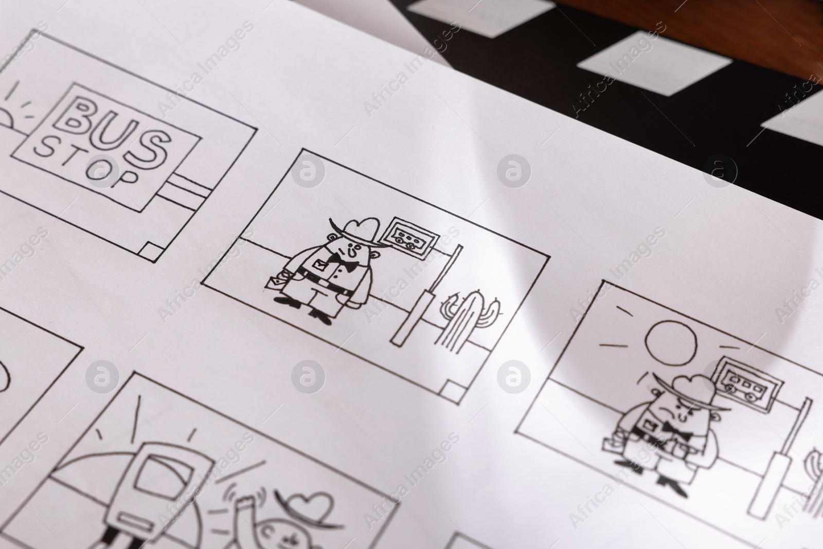 Photo of Storyboard with cartoon sketches at workplace, closeup. Pre-production process