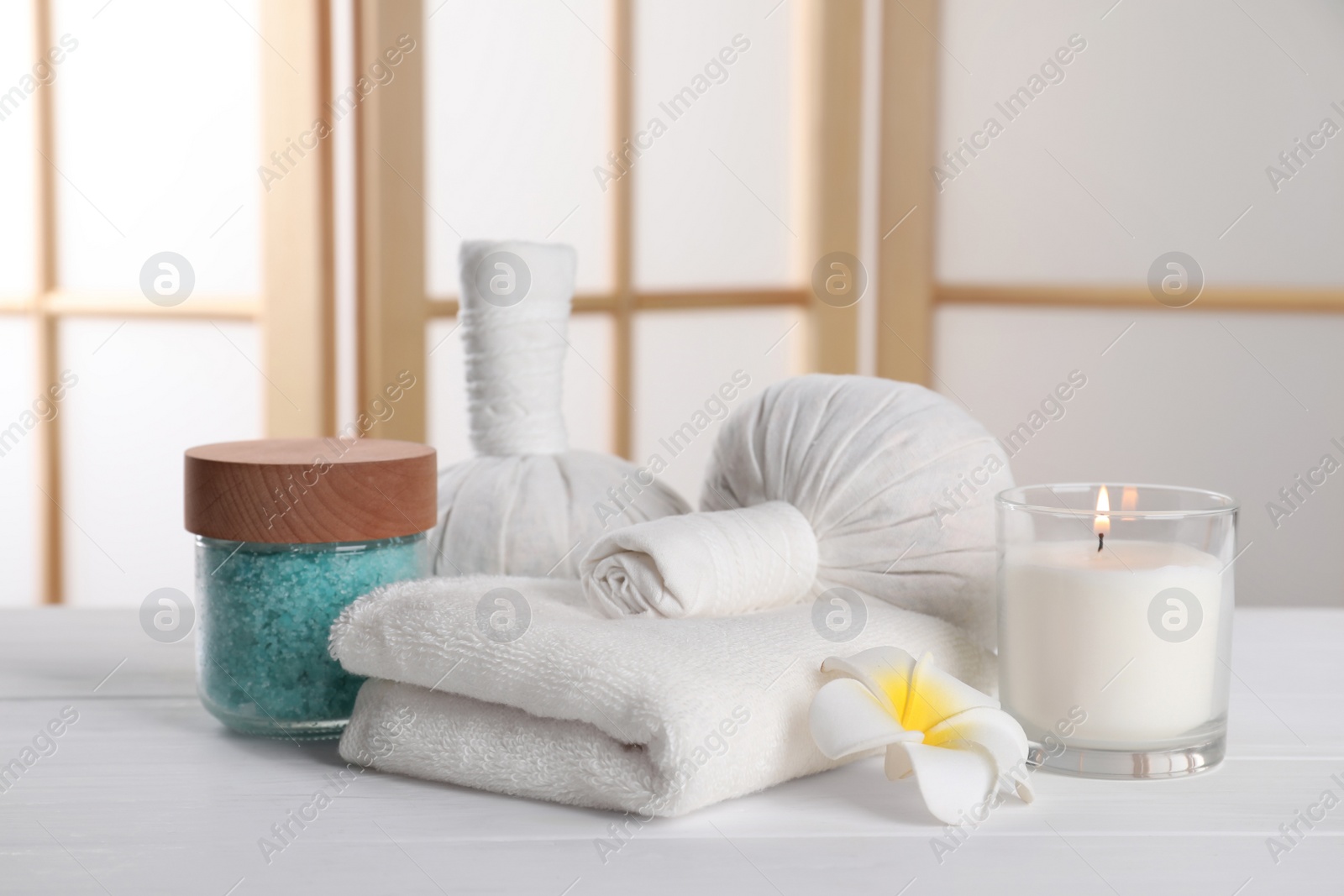 Photo of Spa composition with care products on white wooden table in room