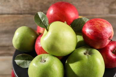 Photo of Fresh ripe red and green apples on wooden table, closeup