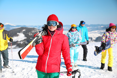 Photo of Young woman with ski at resort. Winter vacation