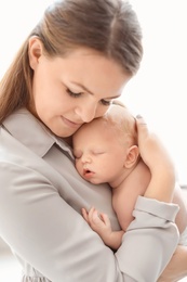 Photo of Young mother with her newborn baby, closeup