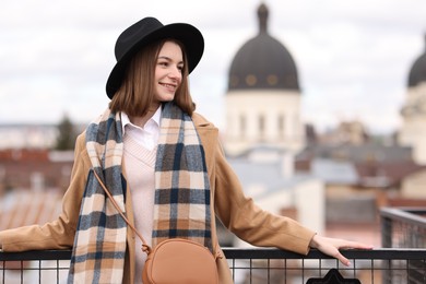 Photo of Beautiful woman in warm scarf and hat outdoors