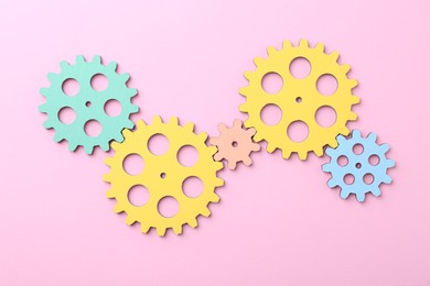 Business process organization and optimization. Scheme with colorful figures on pink background, top view