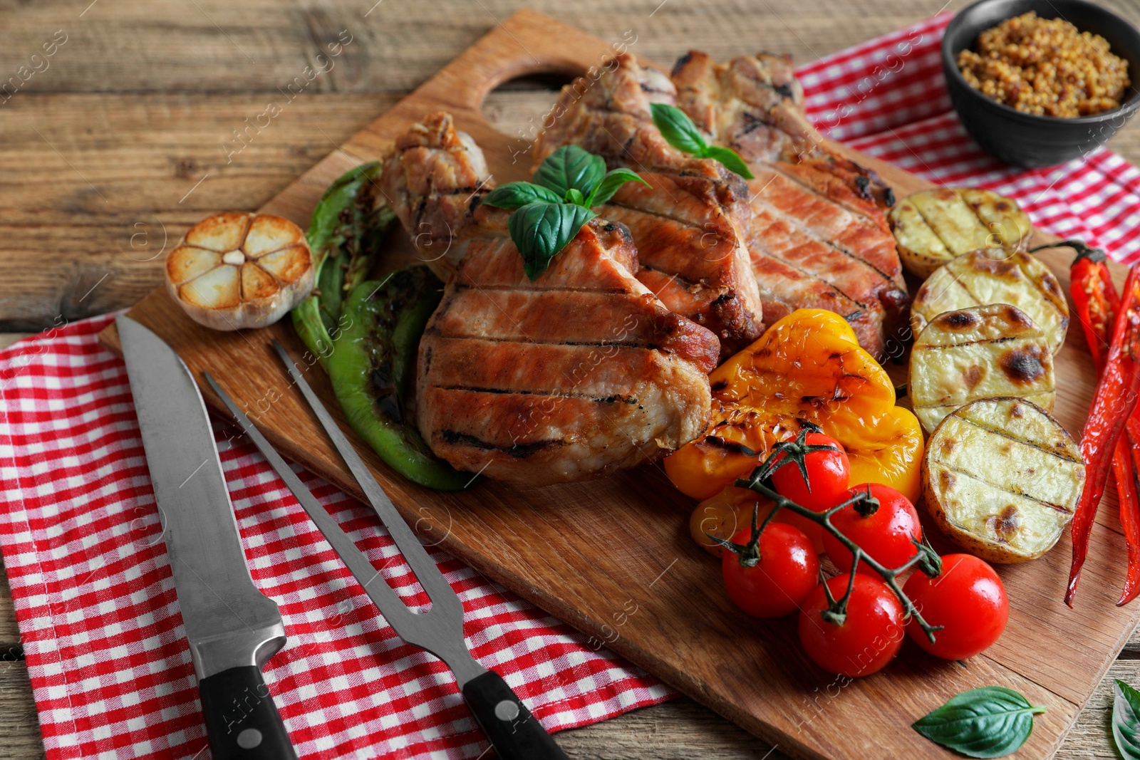 Photo of Delicious grilled meat and vegetables served on wooden table, closeup