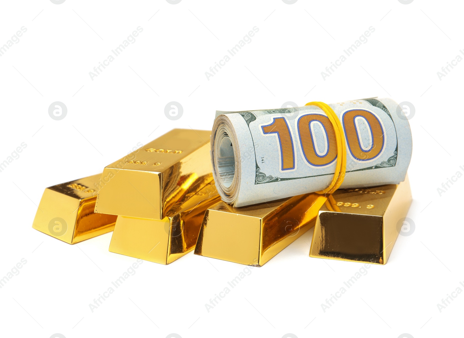 Photo of Shiny gold bars and money on white background