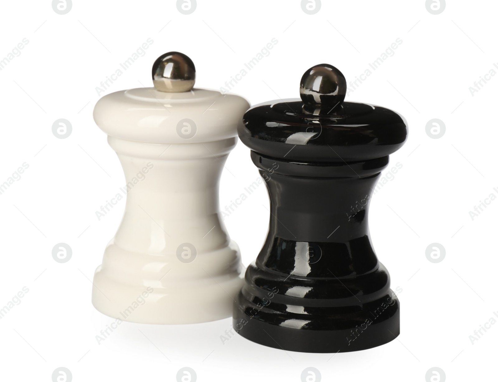 Photo of Wooden salt and pepper shakers isolated on white. Spice mill