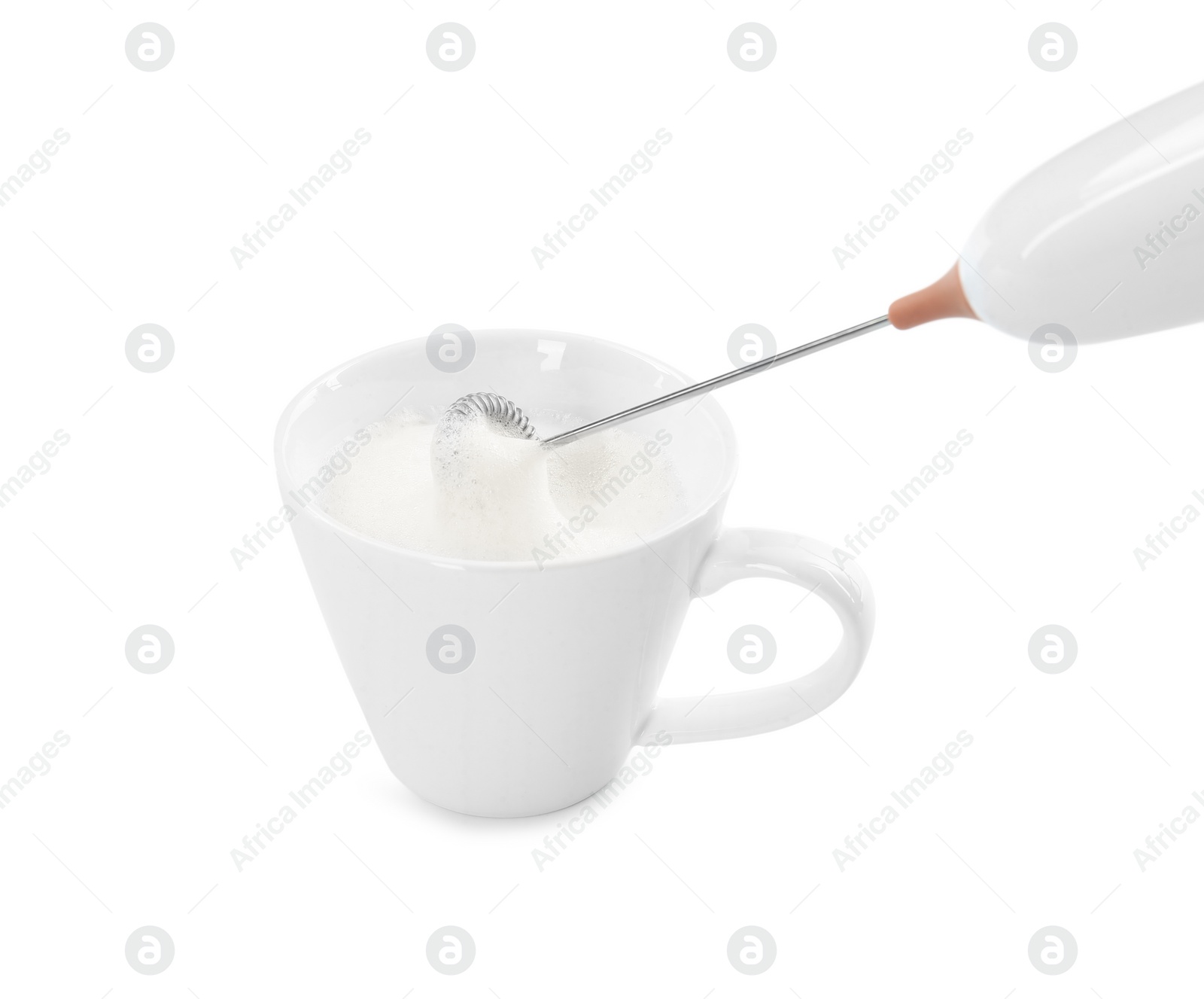 Photo of Whisking milk in cup with mini mixer (frother wand) isolated on white