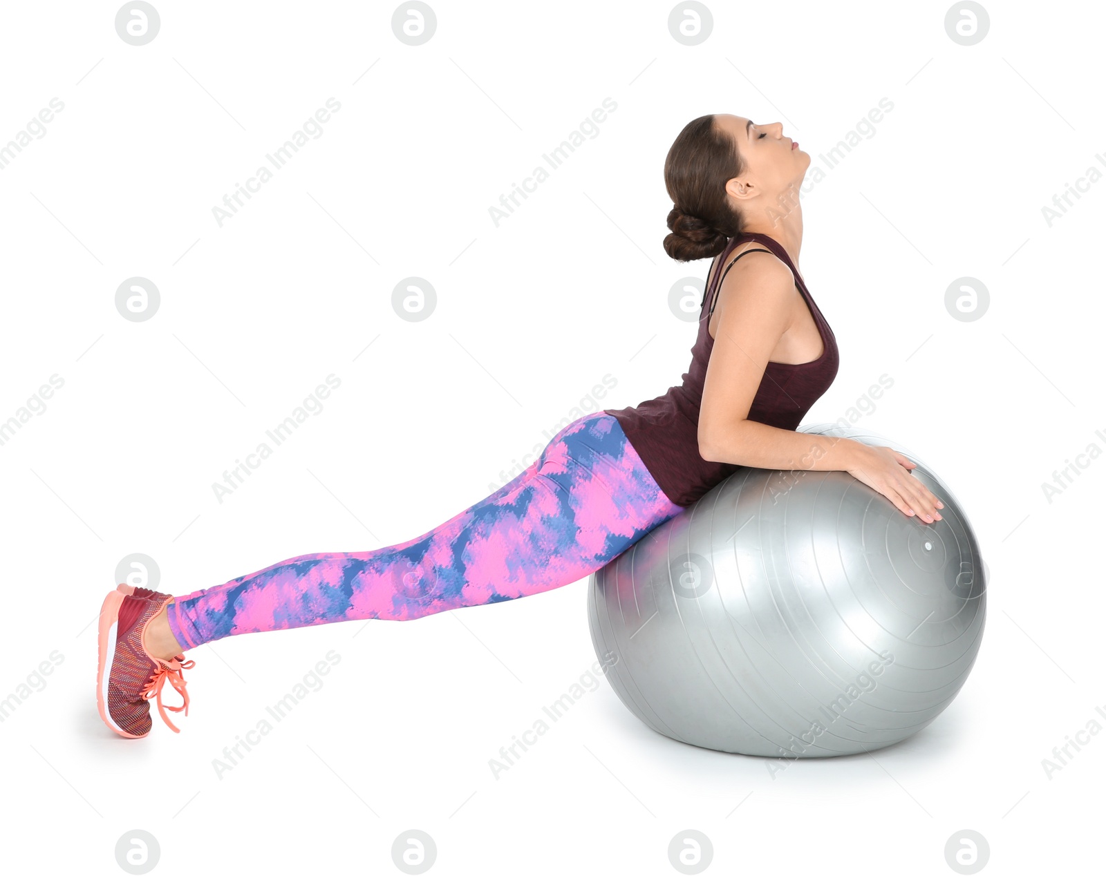 Photo of Young beautiful woman with ball doing exercise on white background. Home fitness