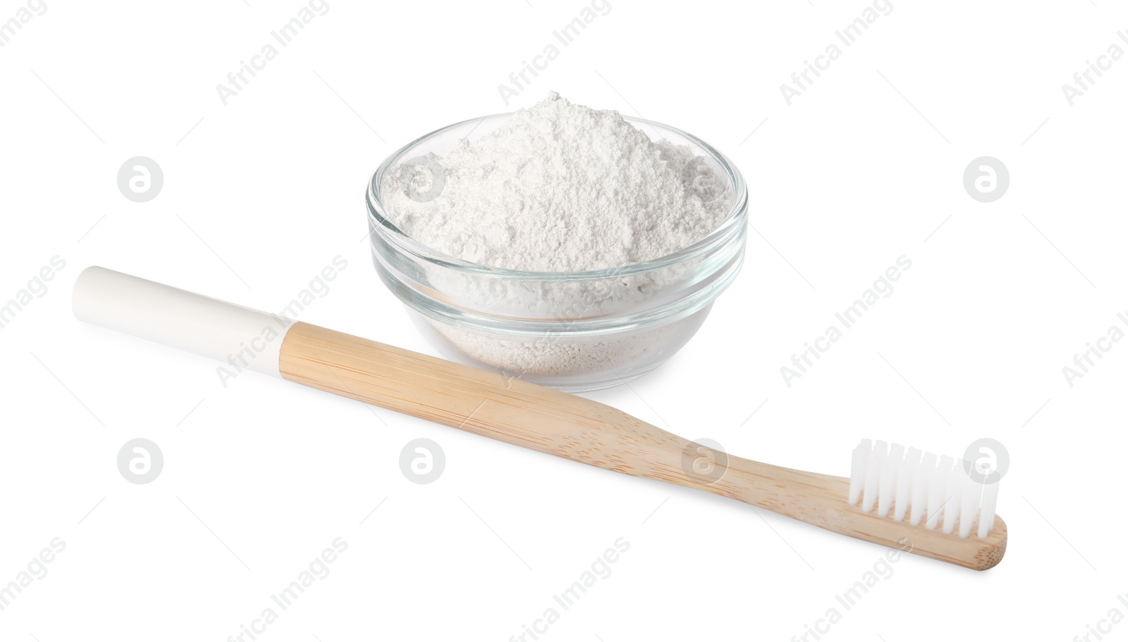 Photo of Glass bowl of tooth powder and brush on white background