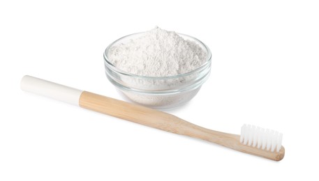 Glass bowl of tooth powder and brush on white background