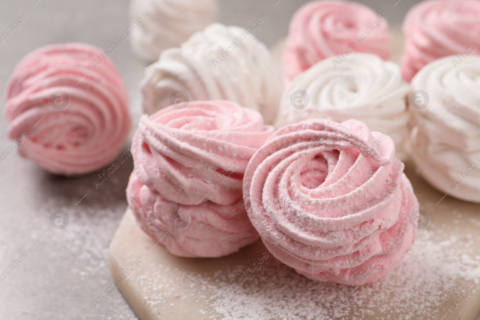 Photo of Delicious pink and white marshmallows on grey table, closeup