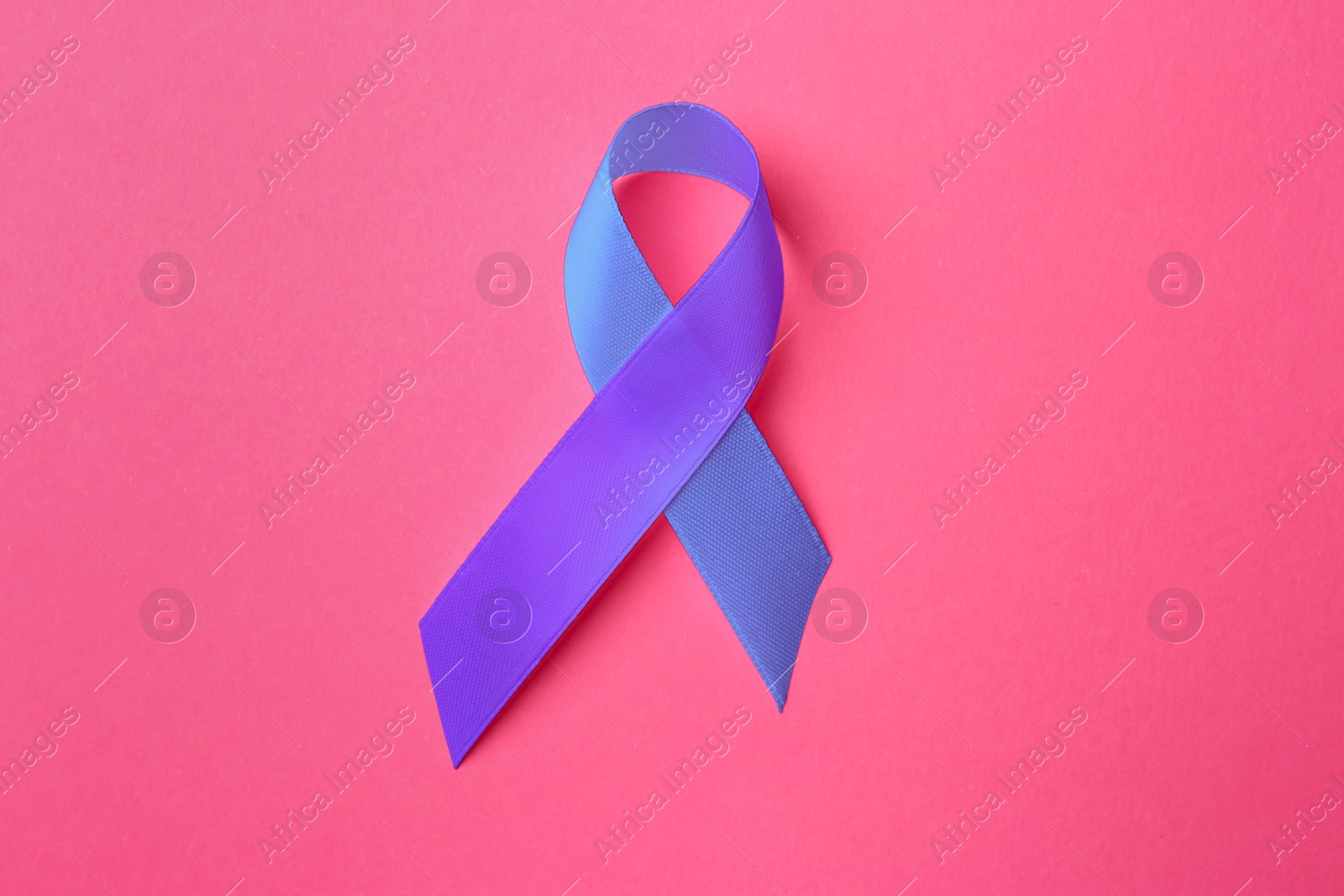 Image of World Arthritis Day. Blue and purple awareness ribbon on pink background, top view