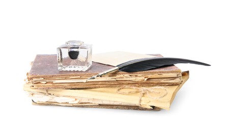 Feather pen, inkwell and old books on white background