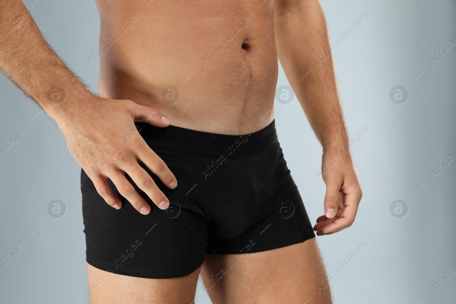 Photo of Man in black underwear on light grey background, closeup