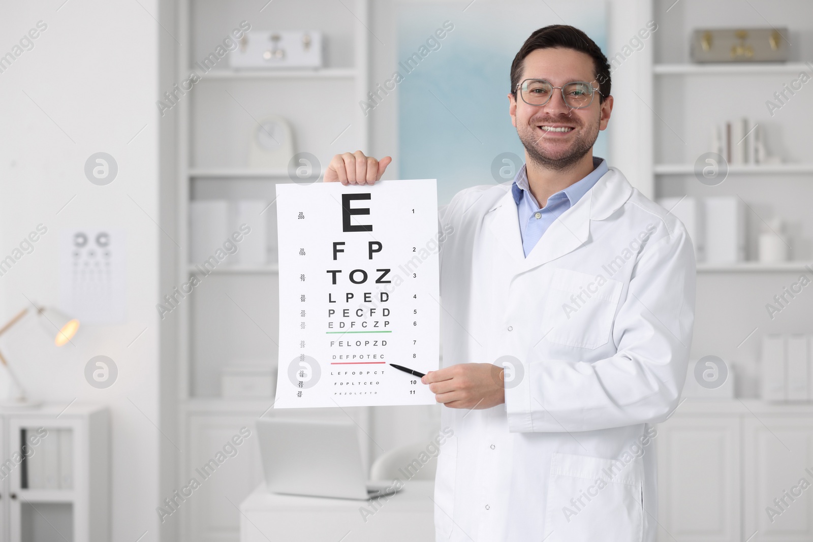 Photo of Ophthalmologist pointing at vision test chart in clinic