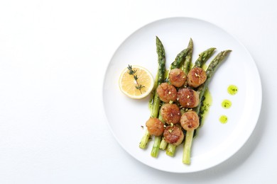Photo of Delicious fried scallops with asparagus, lemon and thyme on white background, top view. Space for text