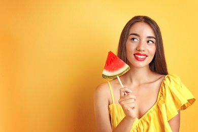 Photo of Beautiful young woman posing with watermelon on color background