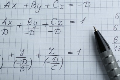 Photo of Sheet of paper with different mathematical formulas and pen, top view