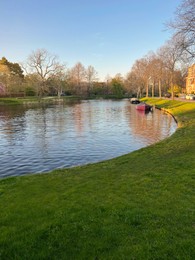 Photo of Picturesque view of beautiful canal with boats on spring day