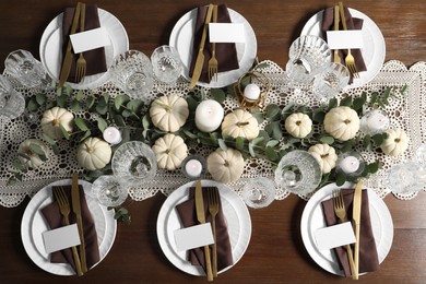 Photo of Beautiful autumn table setting. Plates, cutlery, glasses, blank cards and floral decor, flat lay