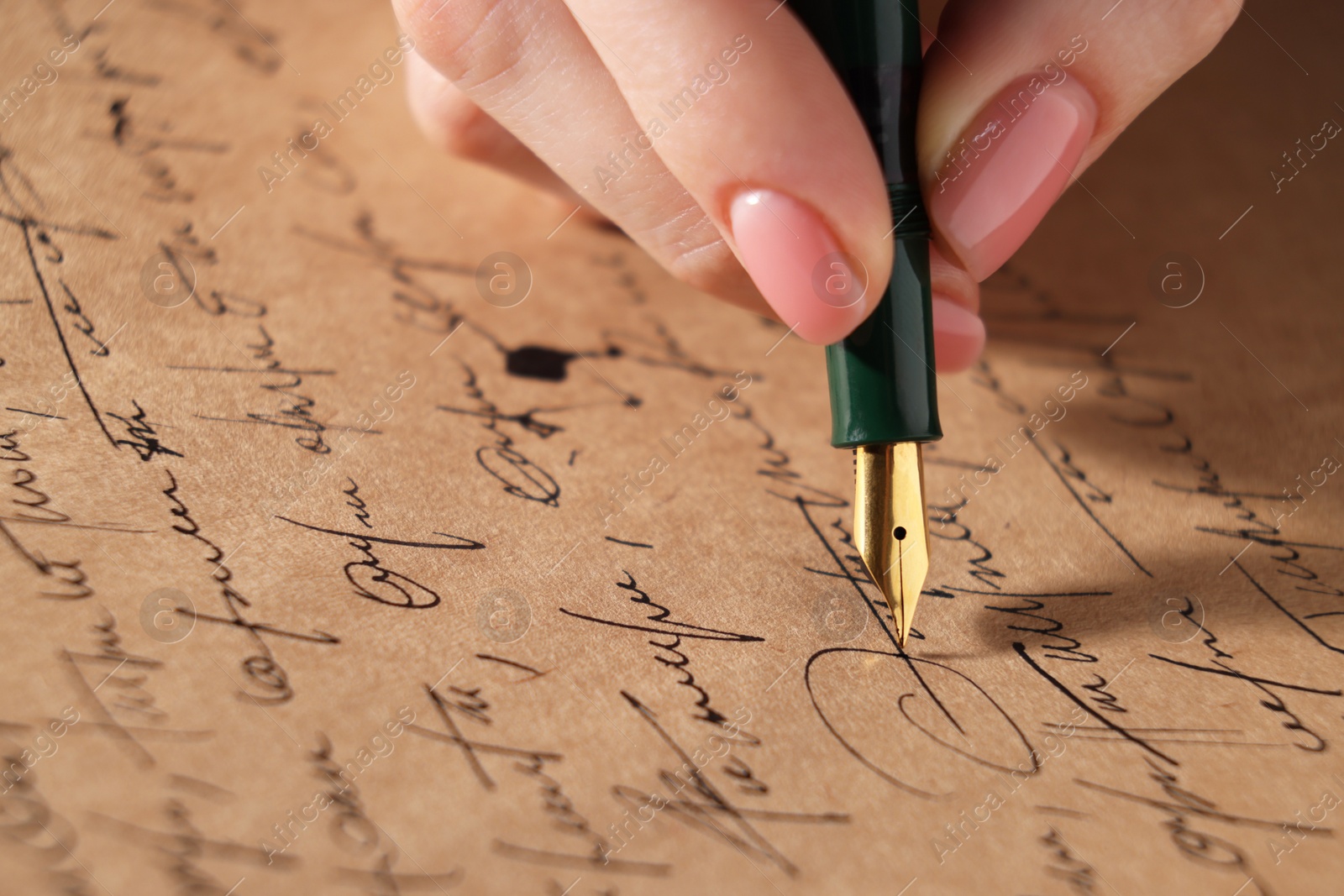 Photo of Woman writing letter with fountain pen, closeup