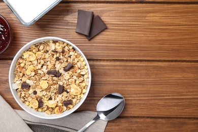 Photo of Tasty muesli served on wooden table, flat lay. Space for text