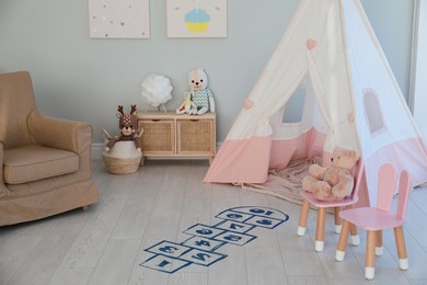 Photo of Beautiful child's room with blue hopscotch floor sticker