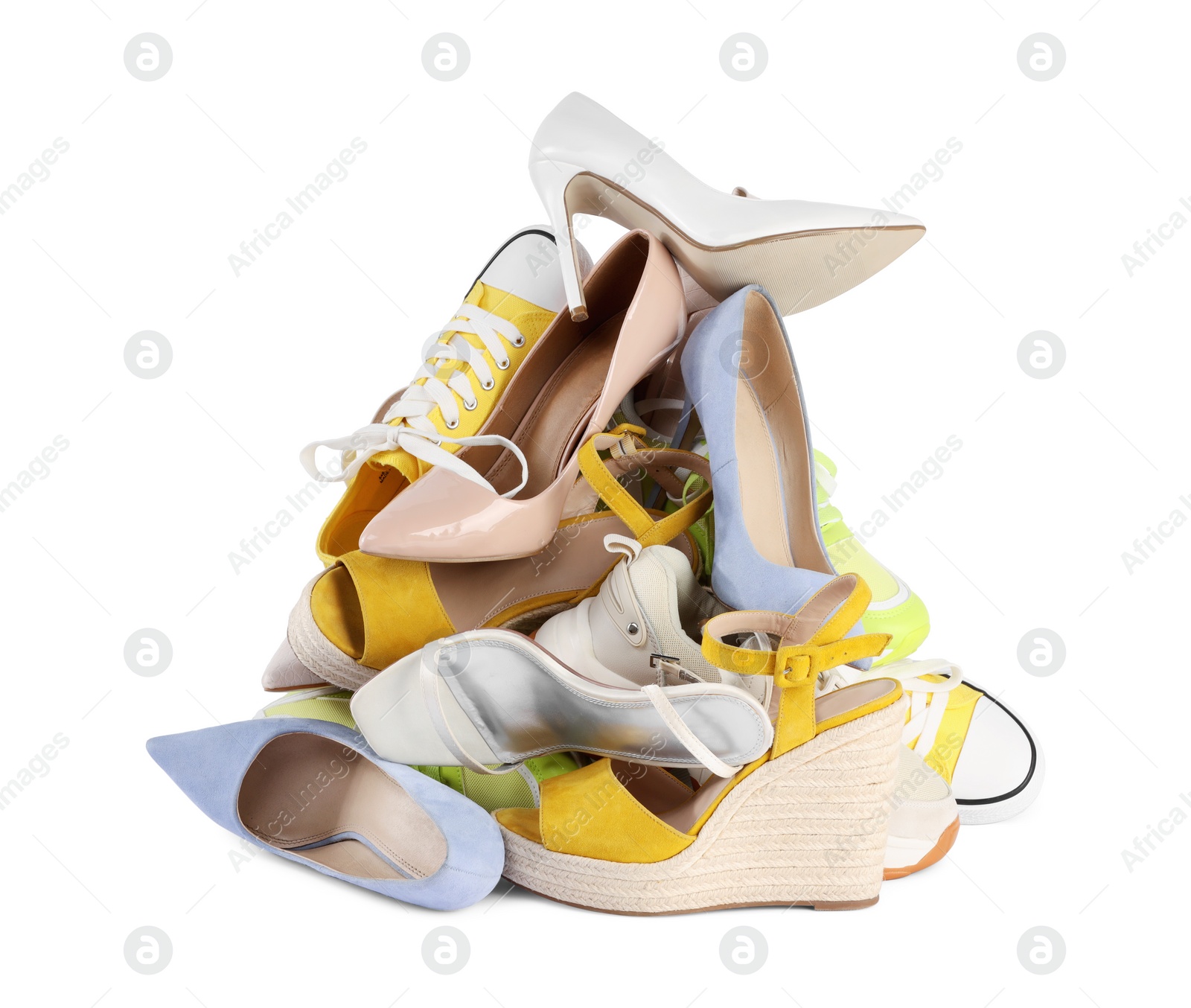 Photo of Pile of different female shoes isolated on white