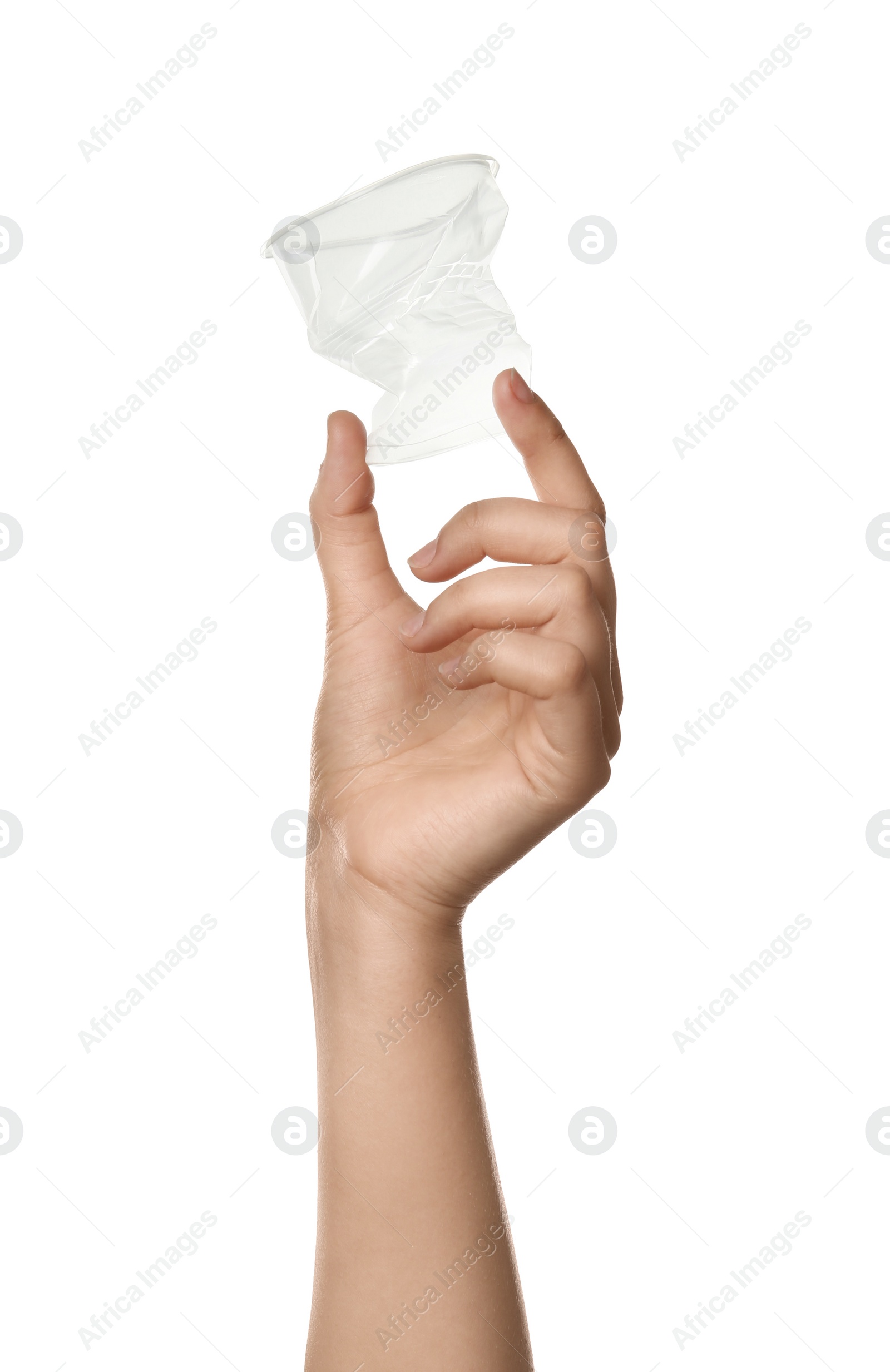 Photo of Woman holding crumpled plastic cup on white background, closeup