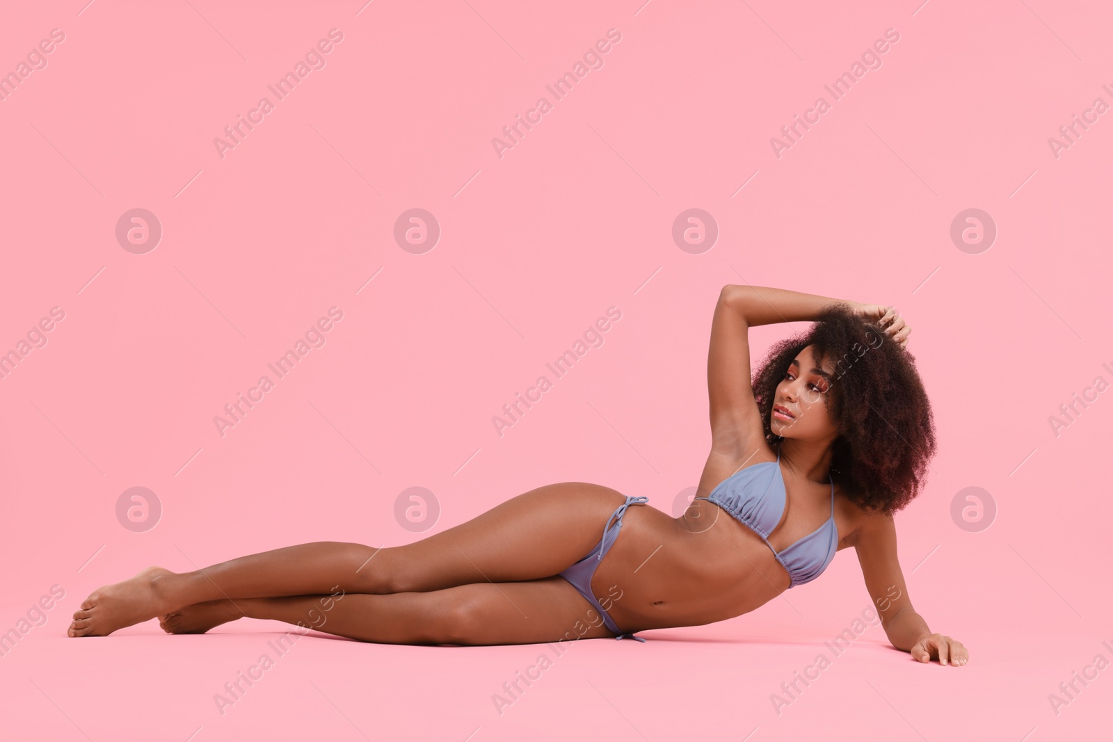 Photo of Beautiful woman in stylish bikini posing on pink background
