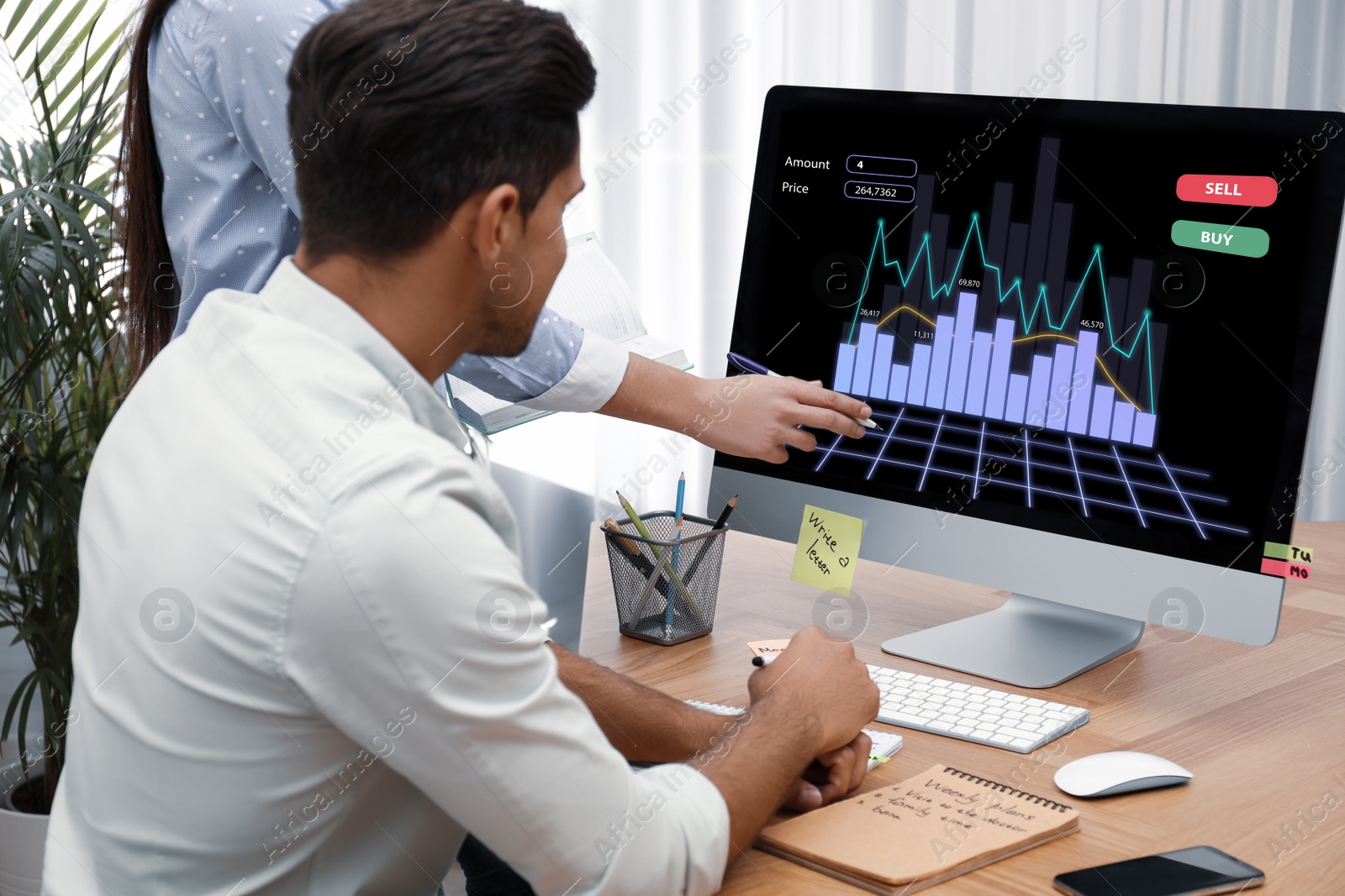 Image of Brokers working with computer in office. Forex trading
