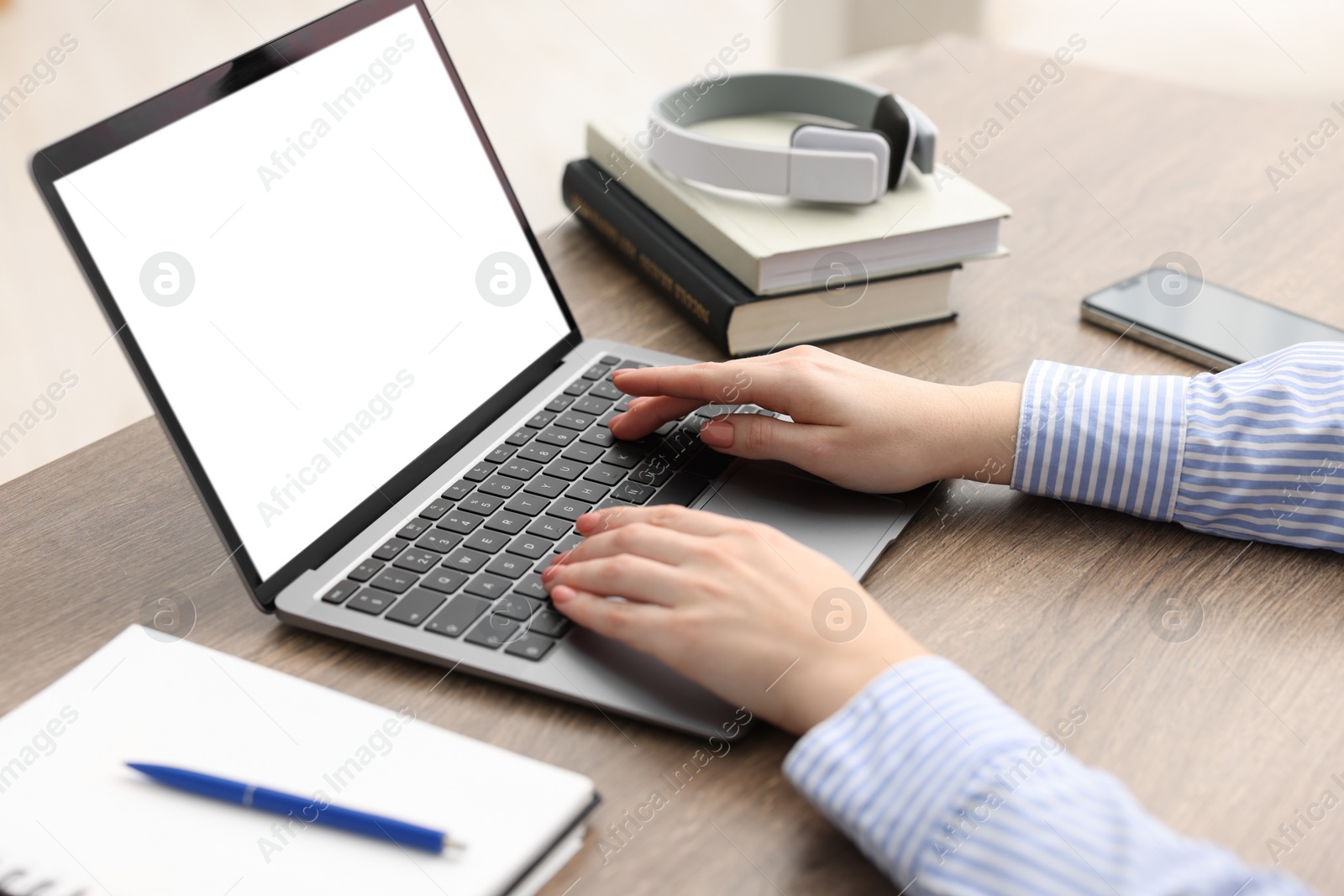 Photo of E-learning. Woman using laptop during online lesson indoors, closeup