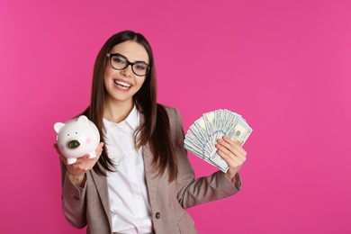 Photo of Businesswoman with money and piggy bank on color background. Space for text