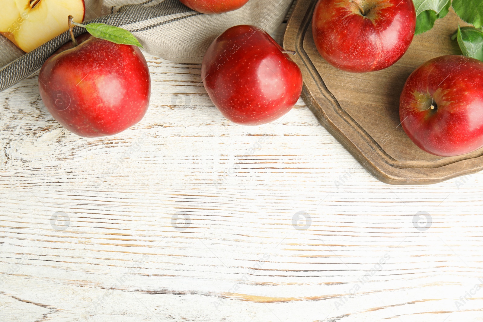 Photo of Ripe juicy red apples on white wooden background, flat lay. Space for text