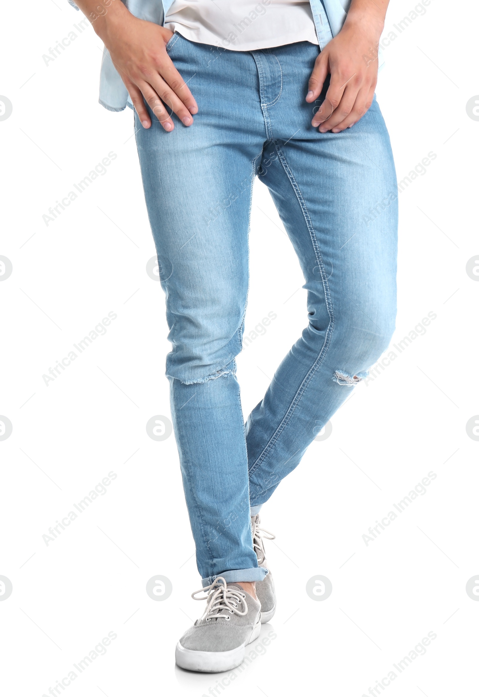 Photo of Young man in stylish jeans on white background