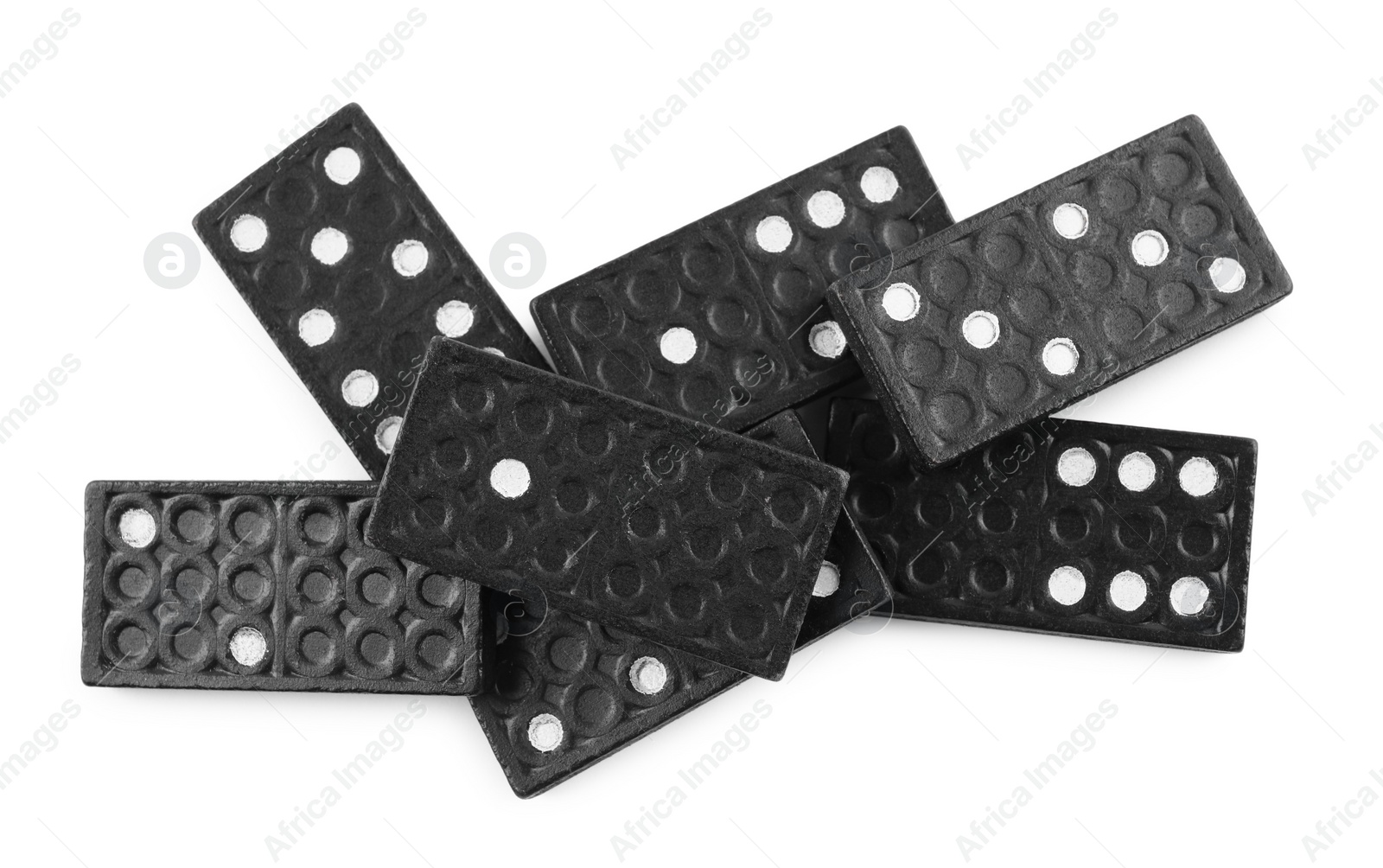 Photo of Pile of black domino tiles on white background, top view