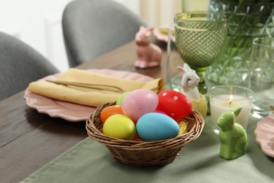 Festive Easter table setting with painted eggs, closeup