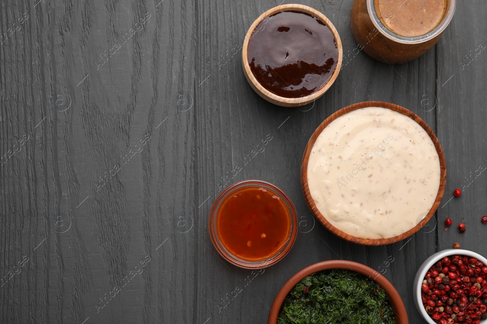 Photo of Different fresh marinades on grey wooden table, flat lay. Space for text