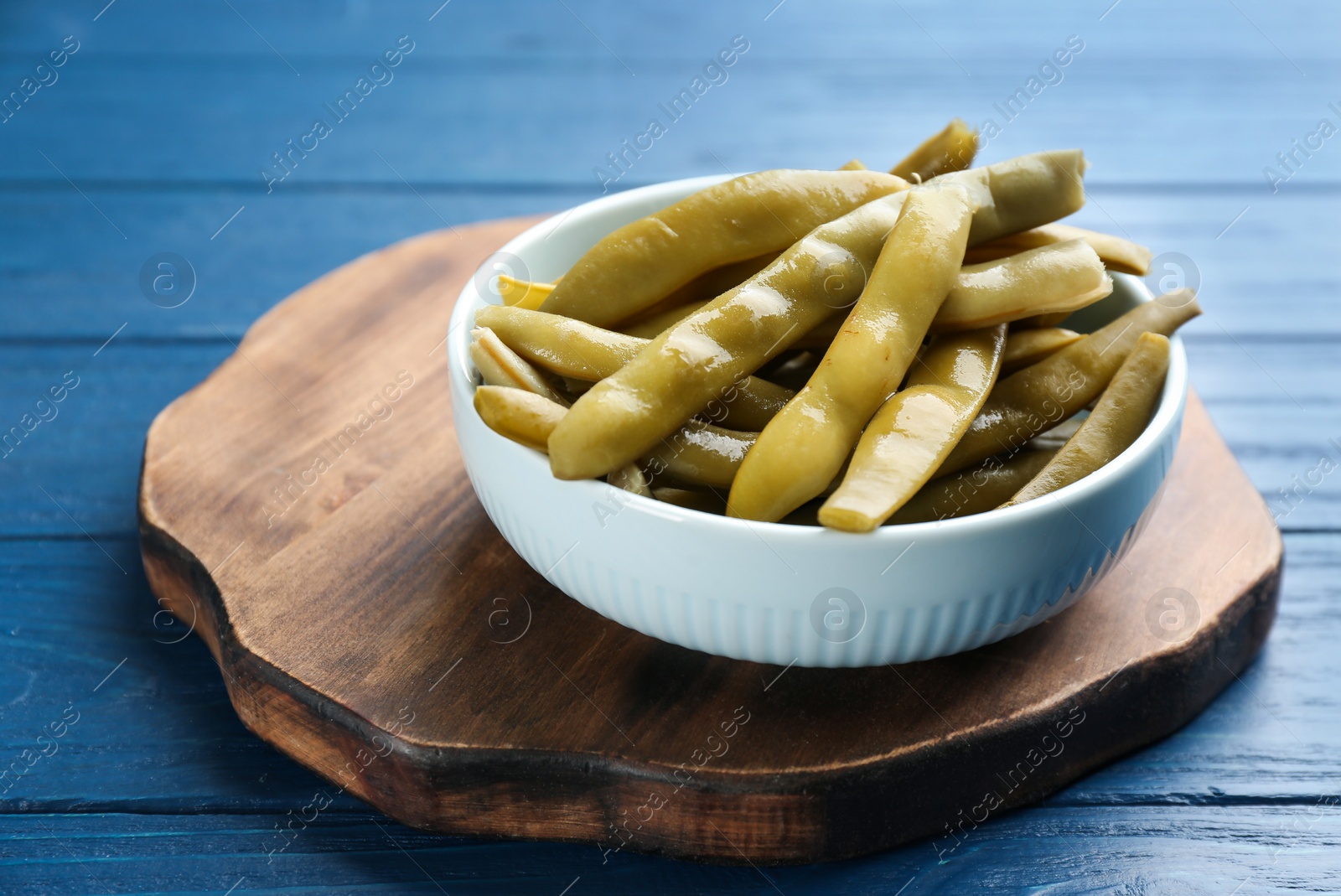 Photo of Canned green beans on blue wooden table