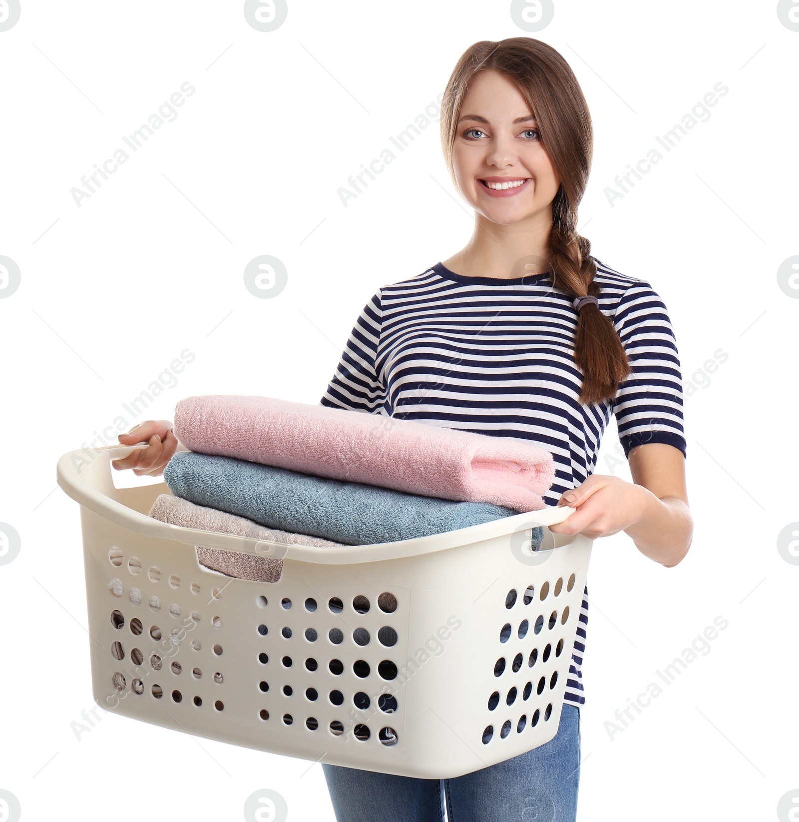 Photo of Happy young woman holding basket with laundry on white background
