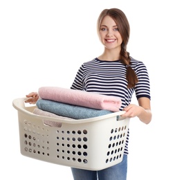 Photo of Happy young woman holding basket with laundry on white background