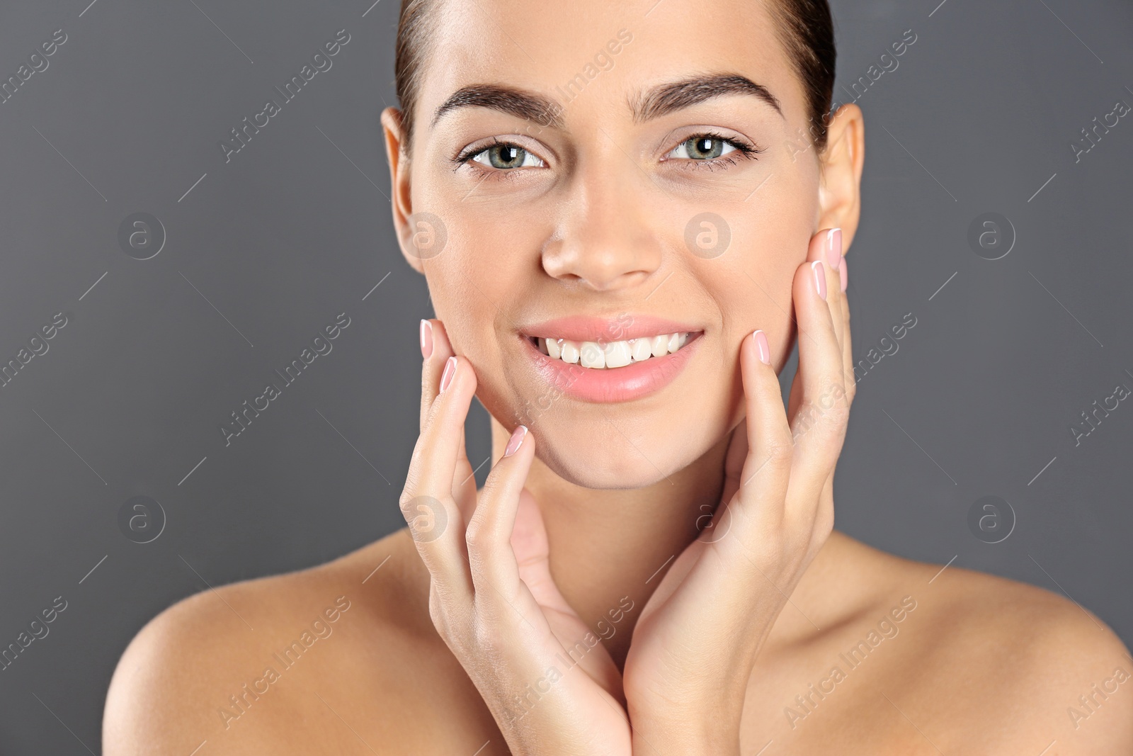 Photo of Portrait of beautiful young woman on grey background. Lips contouring, skin care and cosmetic surgery concept