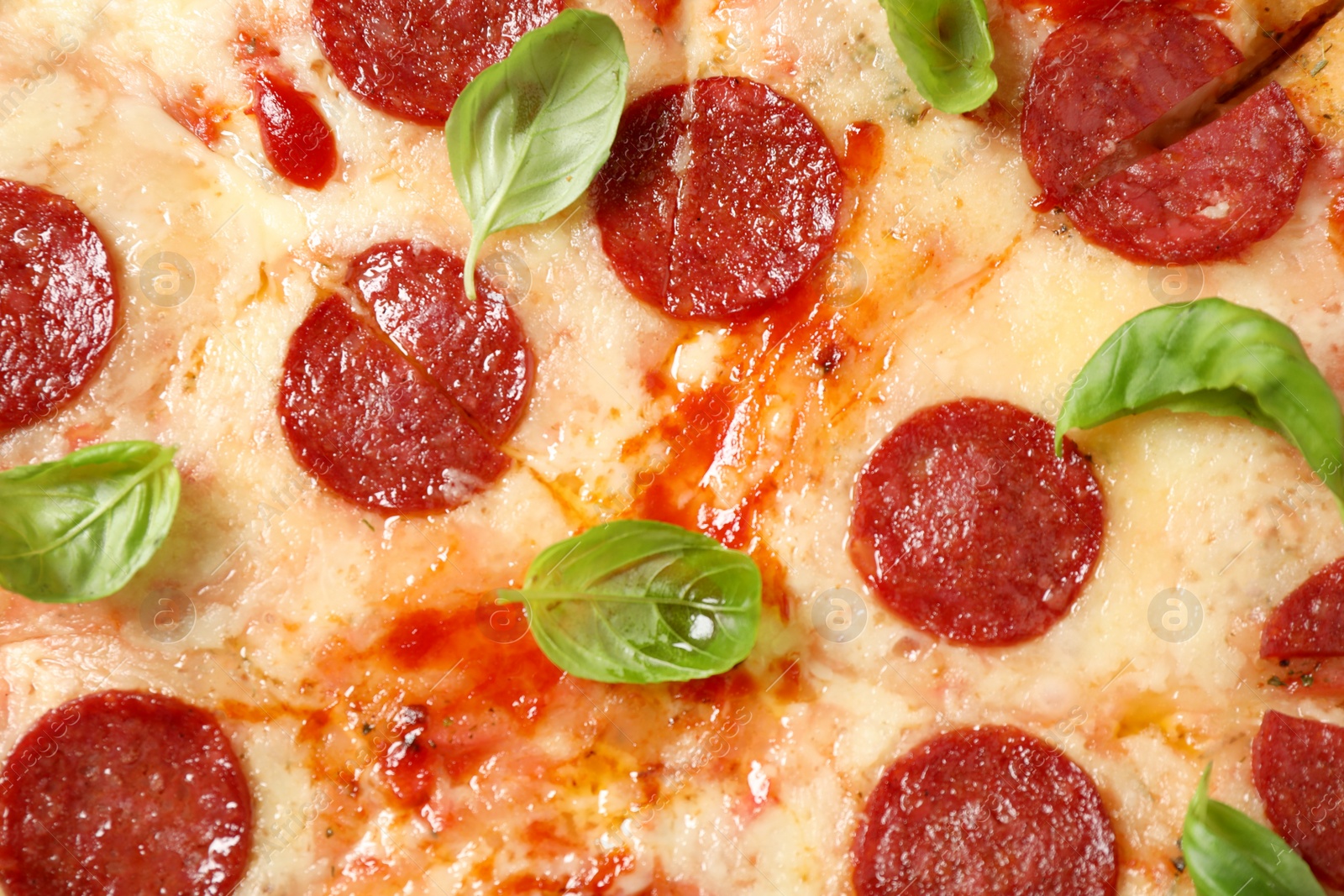 Photo of Hot delicious pepperoni pizza with melted cheese, closeup