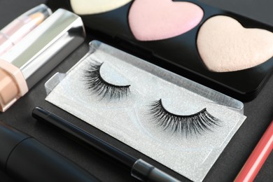 Set of makeup products on dark background, closeup