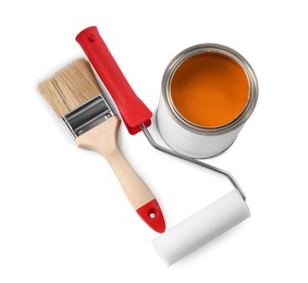 Photo of Can of orange paint, roller and brush on white background, above view
