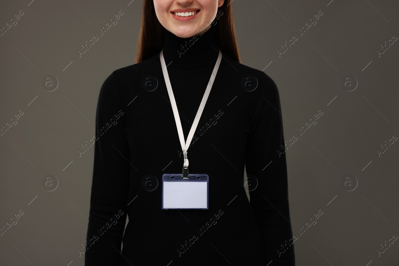 Photo of Woman with blank badge on grey background, closeup