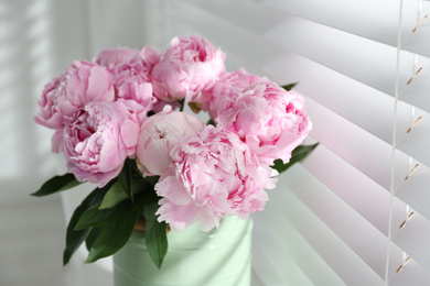 Bouquet of beautiful peonies near window, closeup